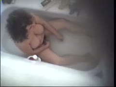 Voyeur reveals her large, delicious melons while masturbating in the restroom.
